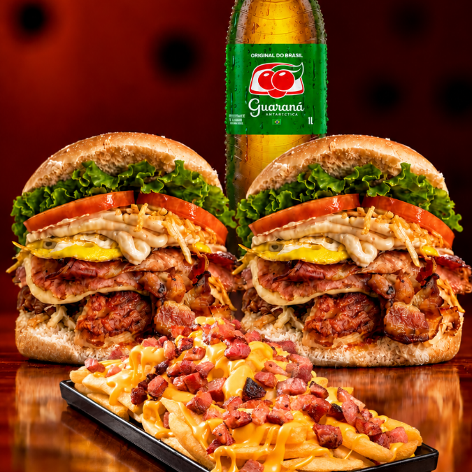 2 X-Tudo à sua escolha, acompanhados de Fritas com cheddar polenguinho e bacon crocante + 1 Guaraná 1L grátis. Um pedido completo, com bastante lanche, fritas caprichadas e bebida para completar.
