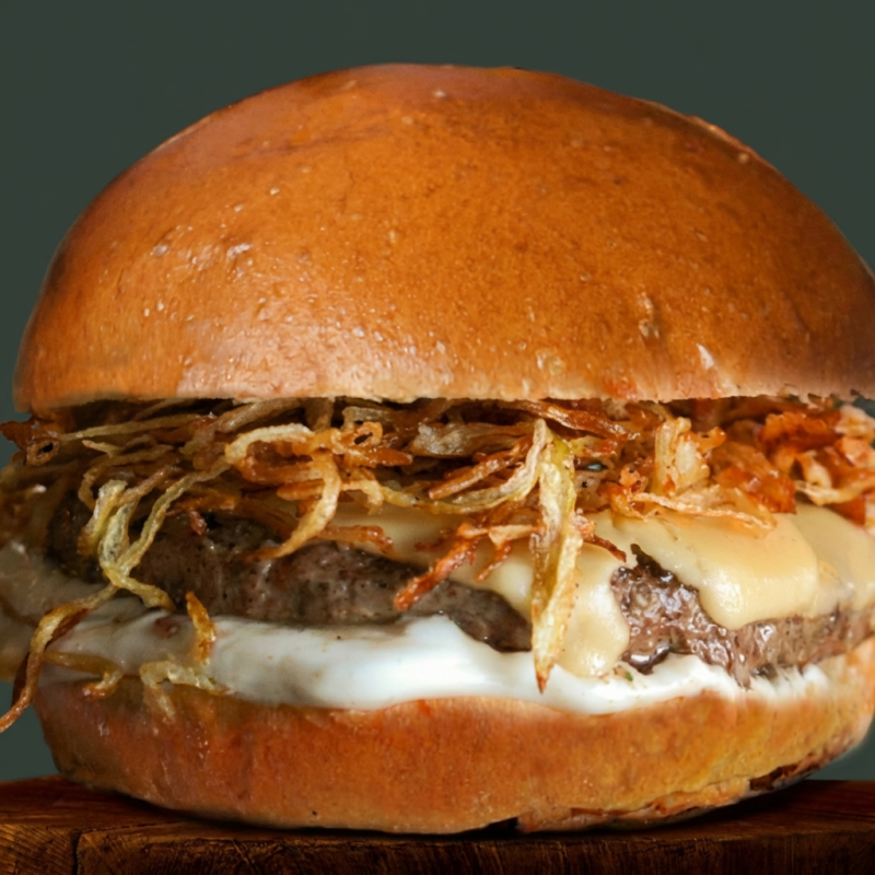 Pão, Queijo American Cheese, Maionese Artesanal, Cebola Crispy, Hambúrguer de Costela Angus 210g.