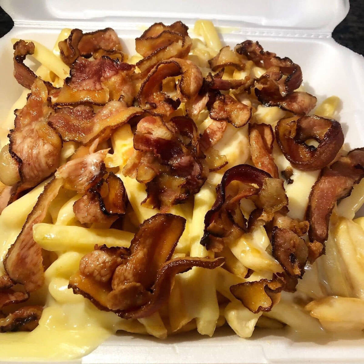 Batata palito frita c/bacon e queijo mussarela acompanhada de nosso suculento molho de alho.