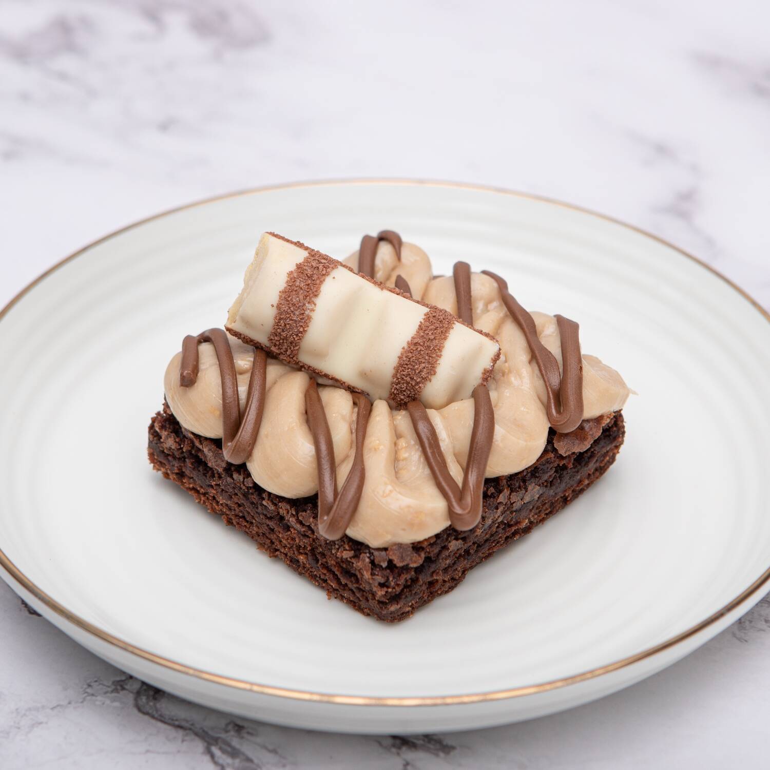 Brownie com creme sabor Bueno, pedaço de Kinder Bueno por cima e finalizado com Nutella.