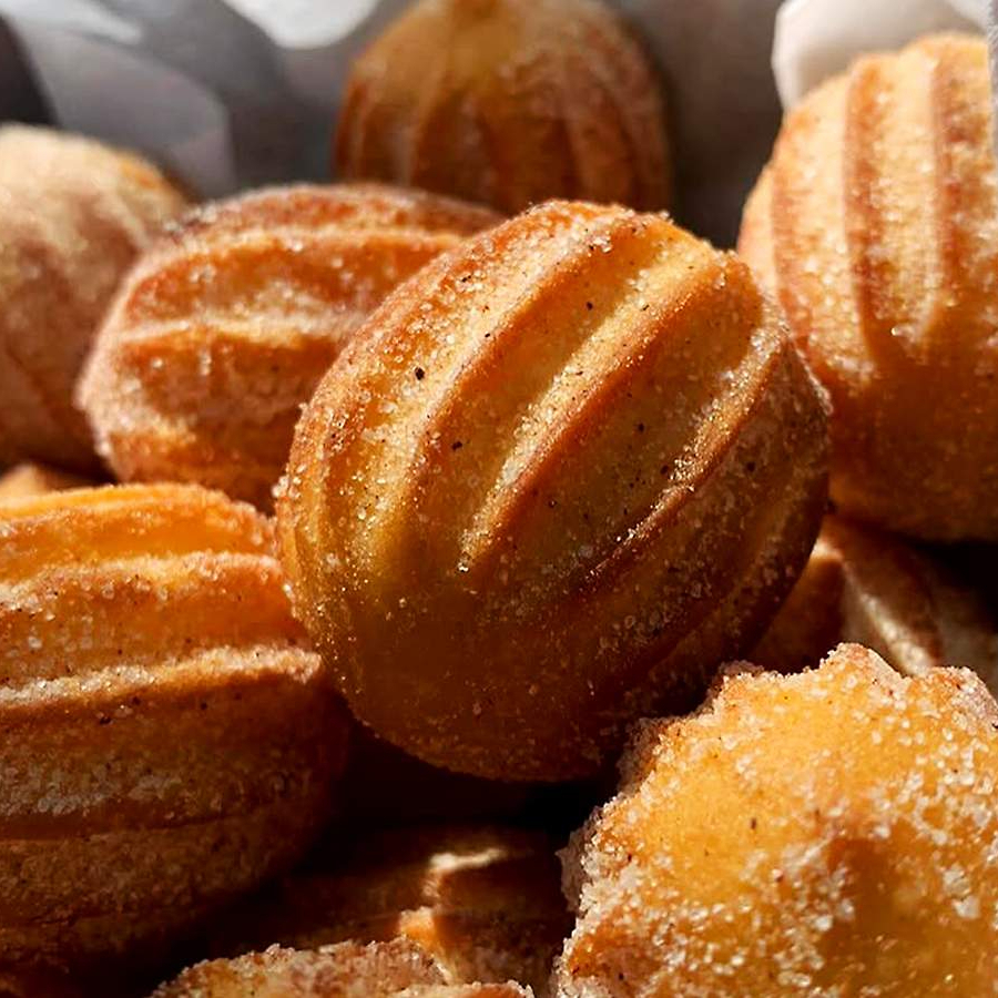 20 mini churros crocantes recheados com doce de leite, perfeitos para dividir.