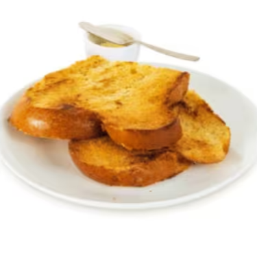 Fatia crocante de pão brioche com manteiga. Quase um patrimônio gastronômico.