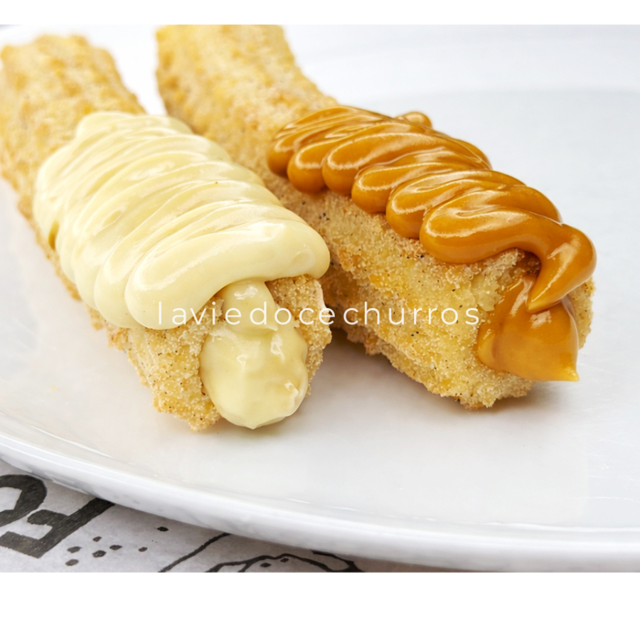 Como não amar essa sensação?! Leve 2 Churros Tradicionais, com recheio e massa levinha e crocante. Recheados com doce de leite e chocolate branco. Curta essa delícia feita com carinho!