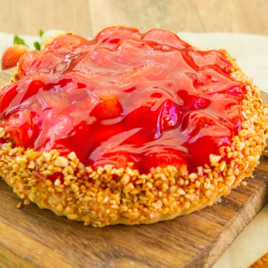 Uau! Olha essa Torta! Feita com base de massa amanteigada, recheio de creme de baunilha com morangos, cobertura de geleia de morango e decorado com castanhas de caju.