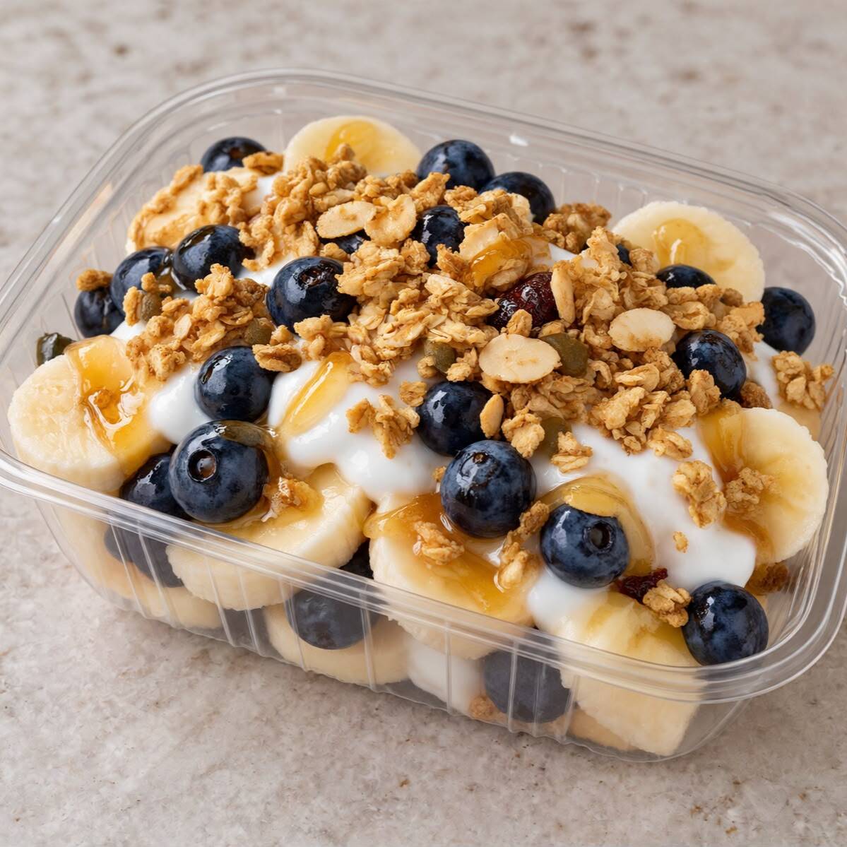 Platano y Blue Berrys con Yogurt, Granola y Miel.