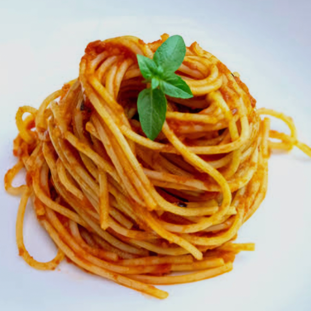 Espaguete al dente envolvido em um clássico molho ao sugo, preparado com tomates selecionados, alho e ervas aromáticas. Finalizado com parmesão ralado na hora, trazendo equilíbrio perfeito entre simplicidade, sabor e tradição da cozinha italiana