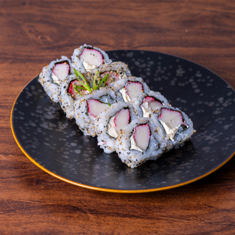 Arroz enrolado no nori, com recheio de kani