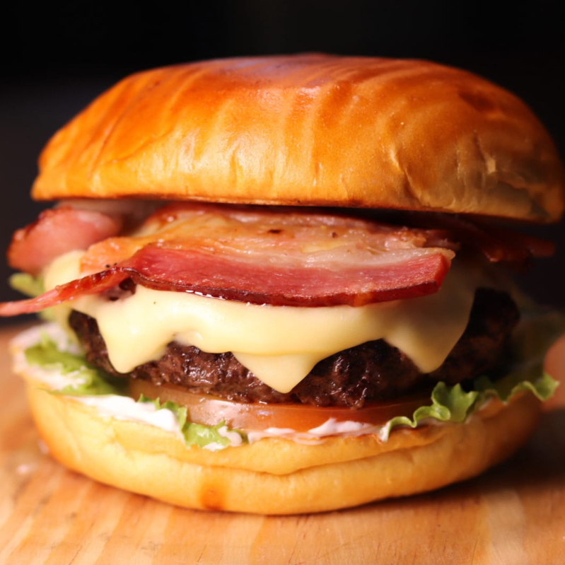 Hambúrguer 160g Envolvido em Trama de Bacon com Muçarela, Cebola Caramelizada, Fatia de Abacaxi, Alface Crocante, Tomate e Molho Taz Maluco para Matar a Fome Mais Maluca.