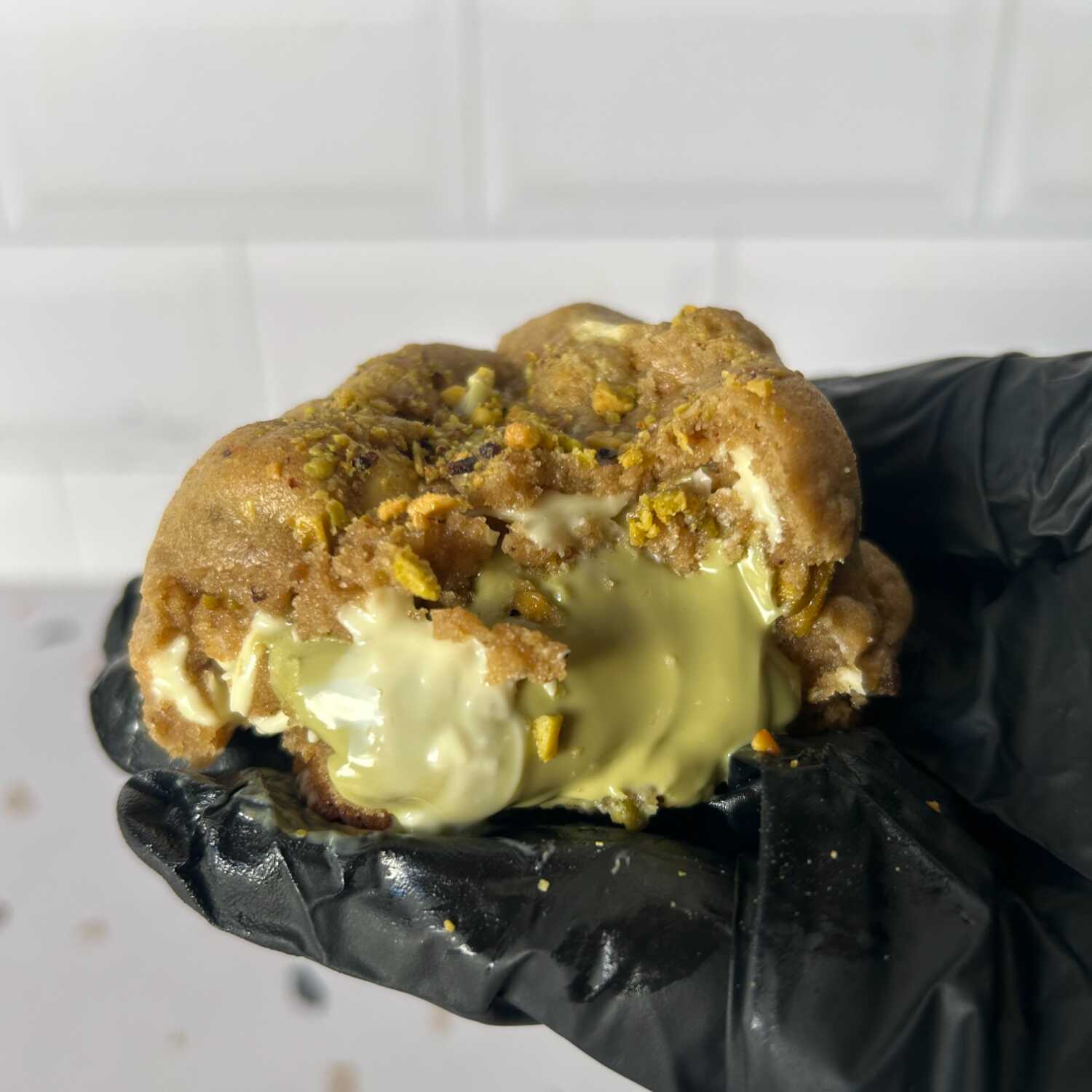 Massa amanteigada com pedaços de chocolate branco e recheio cremoso de pistache. Aprox. 120g