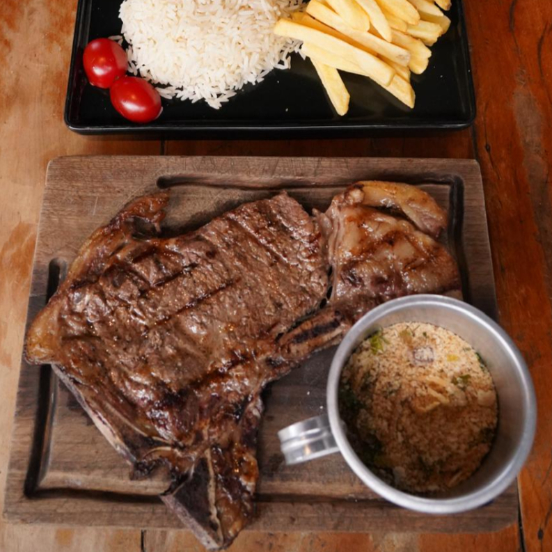 Acompanha Arroz branco, feijão, farofa da casa, fritas e salada.