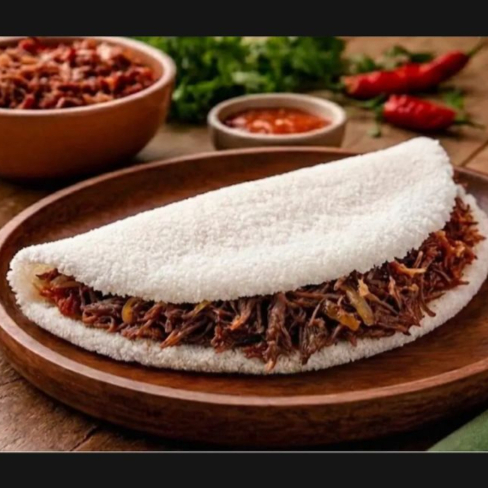 Massa de Tapioca recheada com carne seca desfiada e temperada com alho e cebola.