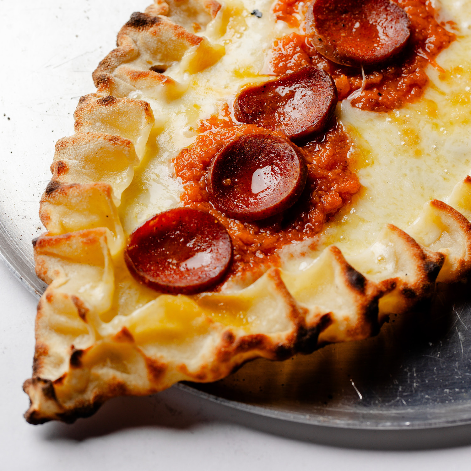 ESFIHA TURCA EM FORMATO DE BARCA, COM MUSSARELA, MOLHO DE TOMATE LEVEMENTE APIMENTADO E SUJUK (LINGUIÇA BOVINA CONDIMENTADA, TÍPICA DO ORIENTE MÉDIO). CONTÉM GLÚTEN. CONTÉM LACTOSE.